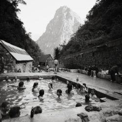 Travelers along the Inca Trail relax in the baths at Aguas Calientes, on their way to the ancient site of Machu Picchu, Peru.