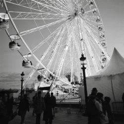 Pedestrians at Place de la Concorde near Ferris Wheel along the Historical Axis of Paris, France.